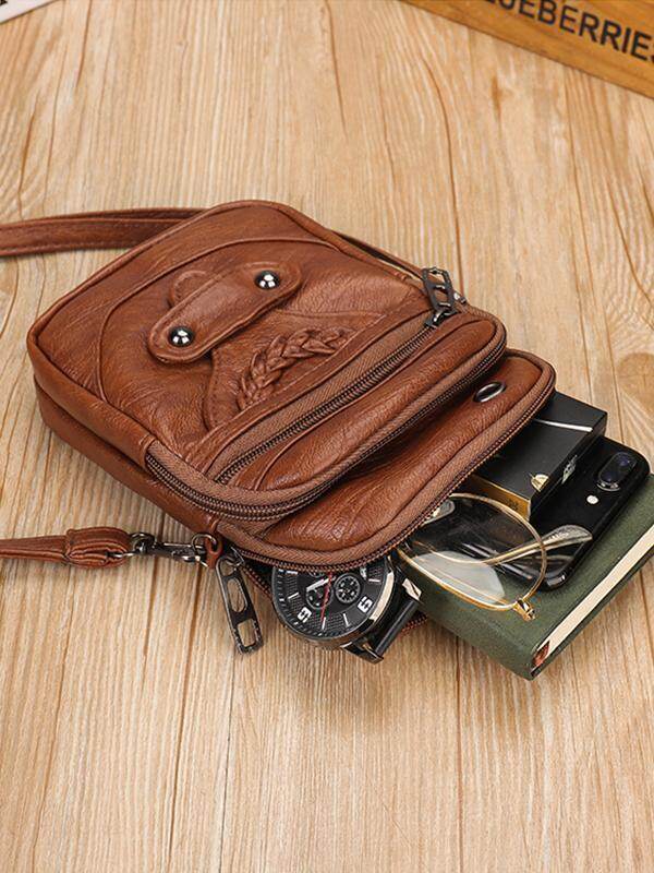 Bolsa crossbody de couro com tachas e tachas