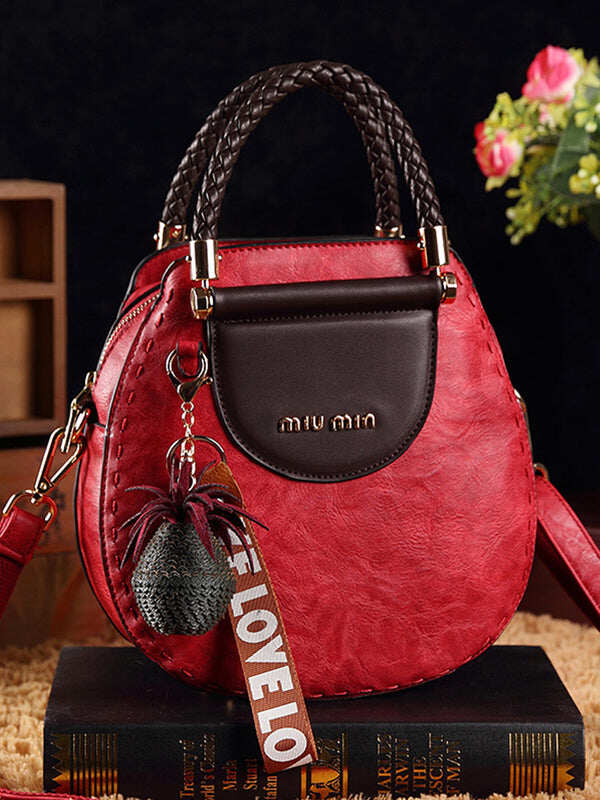 Bolsas em pele vintage formato redondo com borlas. Bolsa de ombro